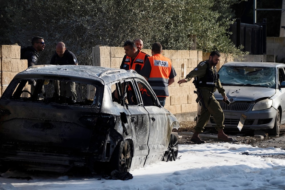 Members of the Israeli occupation forces work at the site where a rocket fired from Lebanon hit an area in the town of Nahariya, northern occupied Palestine, Thursday, Nov. 21, 2024. (AP)