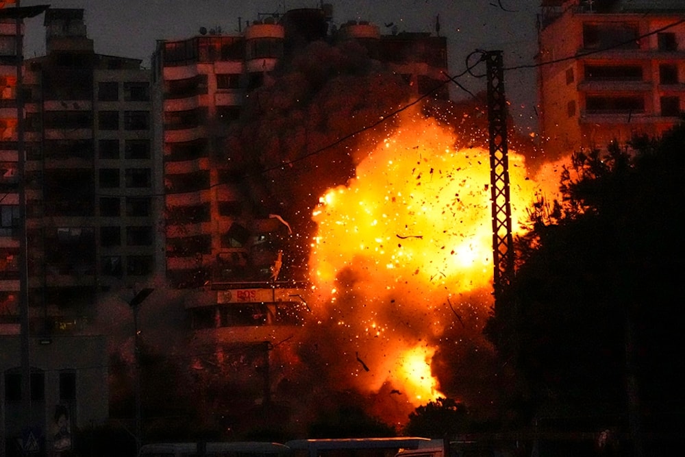 Thick smoke, flames and debris erupt from an Israeli airstrike that targeted a building in Tayouneh, Beirut, Lebanon, Monday, November 25, 2024 (AP)