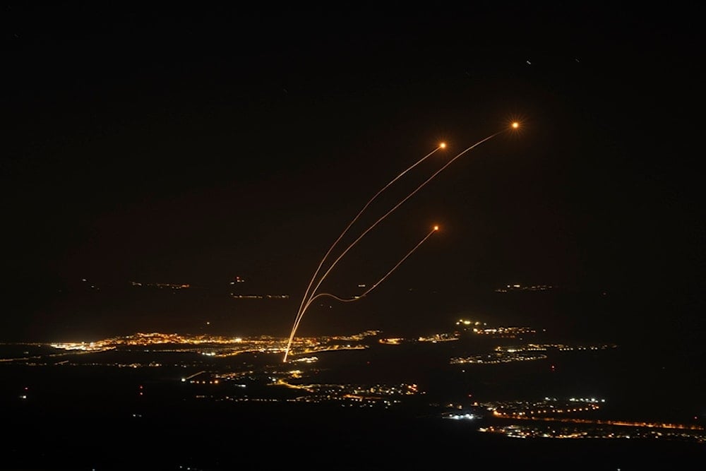 The Israeli Iron Dome air defense system fires to try and intercept rockets launched from Lebanon, near Kiryat Shmona, as seen from the Israeli-occupied Syrian Golan Heights, Oct. 26, 2024. (AP)