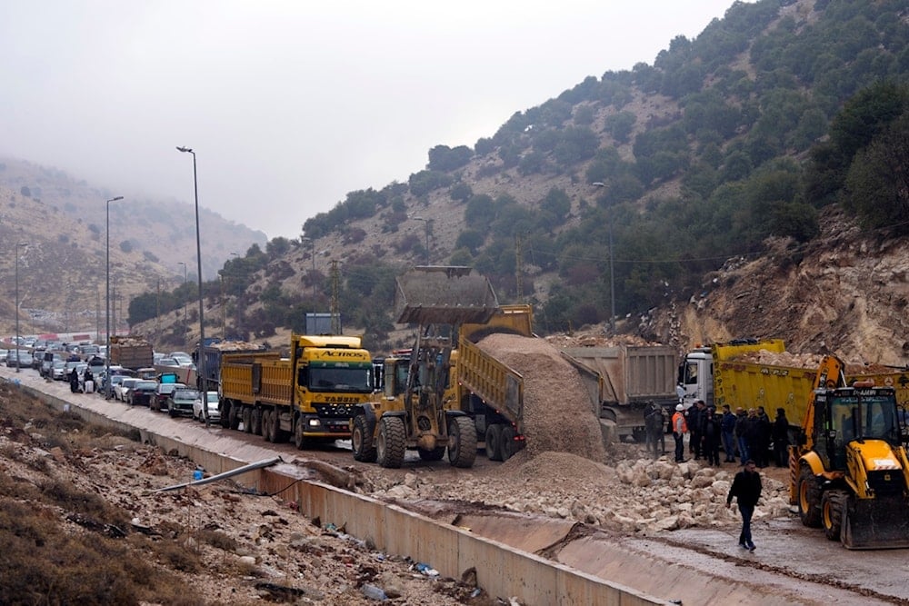 Displaced residents returning from Syria sit in traffic amid roadworks to reopen al-Masnaa border crossing, eastern Lebanon, following the ceasefire in Lebanon and 'Israel',on Nov. 27, 2024. (AP)