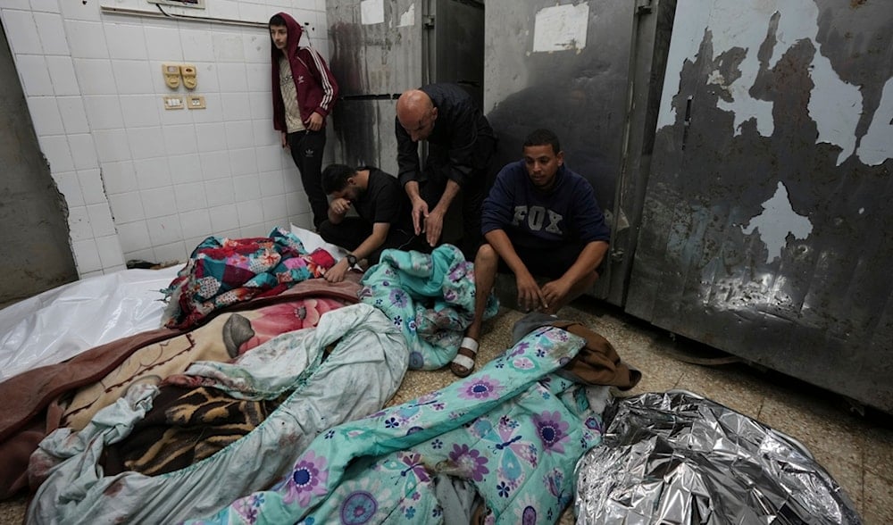 Palestinians mourn over relatives killed in an Israeli occupation bombardment in Nuseirat, central Gaza, as they stand in a hospital morgue in Deir al-Balah, Gaza Strip, Palestine, Nov. 20, 2024. (AP)