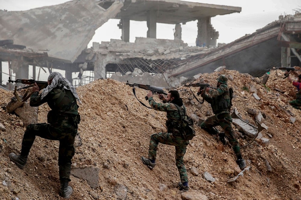 Syrian army soldiers fire their weapons during a battle with terrorist fighters at the Ramouseh front line, east of Aleppo, Syria, Dec. 5, 2016. (AP)