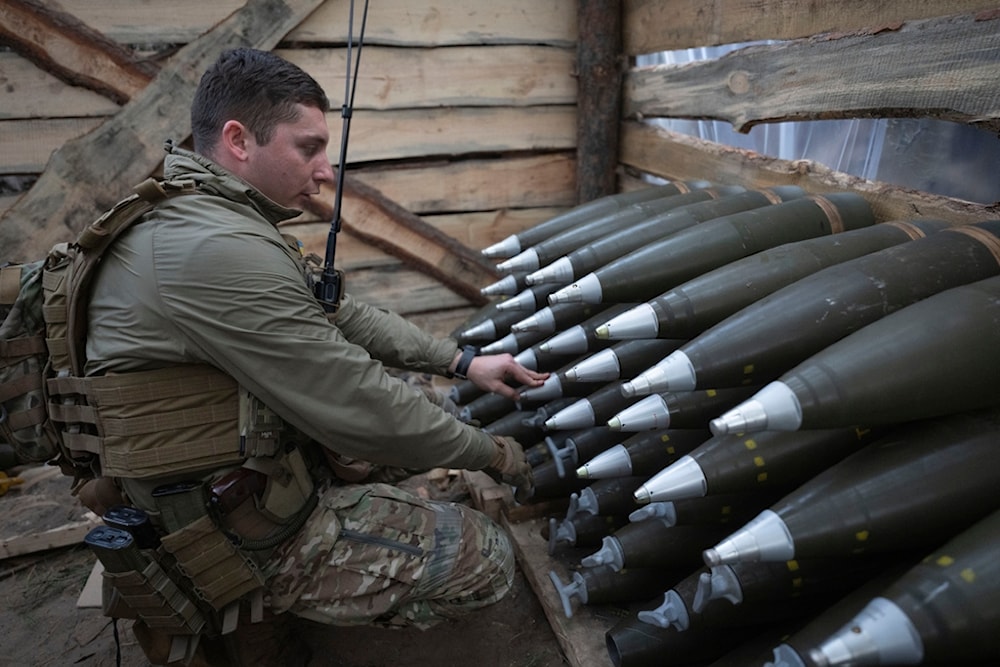 A Ukrainian officer of the 92nd separate assault brigade inspects ammunition in a shelter on the frontline near Vovchansk, Kharkiv region, Ukraine, Monday, Oct. 28, 2024. (AP Photo/Efrem Lukatsky)