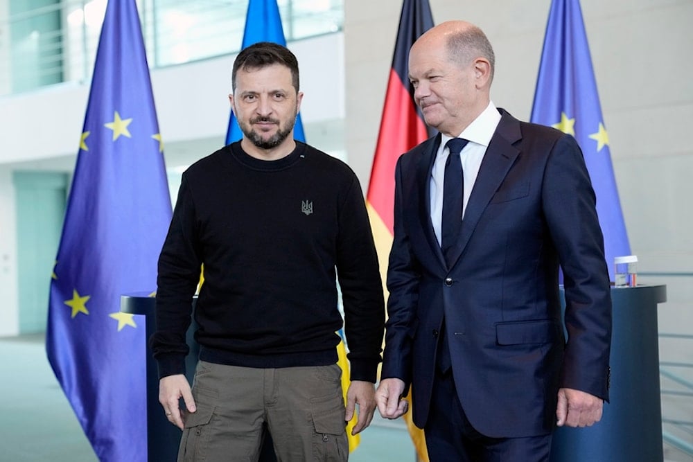 Ukraine's president Volodymyr Zelenskyy and German chancellor Olaf Scholz leave after a statement at the chancellery in Berlin, Germany, Friday, Oct. 11, 2024. (AP)