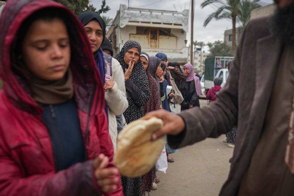 Palestinian women and children queue for bread in Deir al-Balah, Gaza Strip, Thursday, November 28, 2024 (AP)