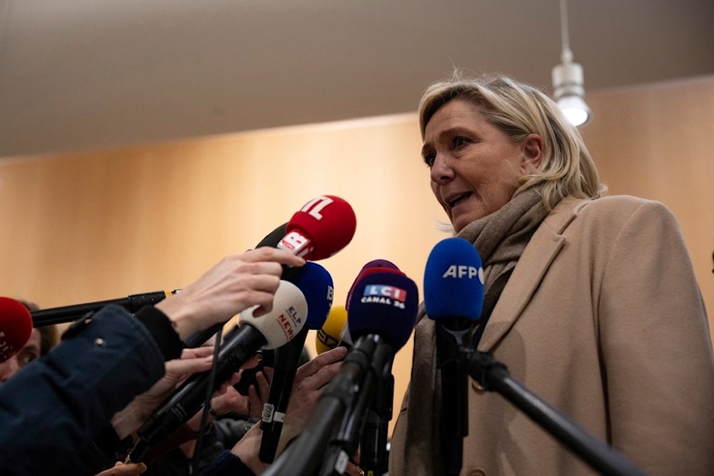 French right-wing leader Marine Le Pen answers reporters after the last day of the trial on charges of embezzling European Parliament funds, in Paris, Wednesday, Nov. 27, 2024. (AP)