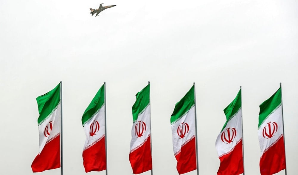 In this photo released by the official website of the office of the Iranian Presidency, a fighter jet flies over Iranian flags during the army parad, just outside Tehran, Iran, April 18, 2019. (AP)