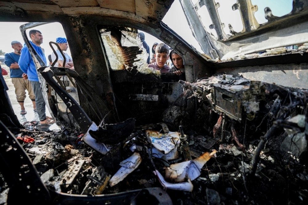 People inspect the site where World Central Kitchen workers were killed in Deir al-Balah, Gaza Strip, Tuesday, April 2, 2024. (AP)