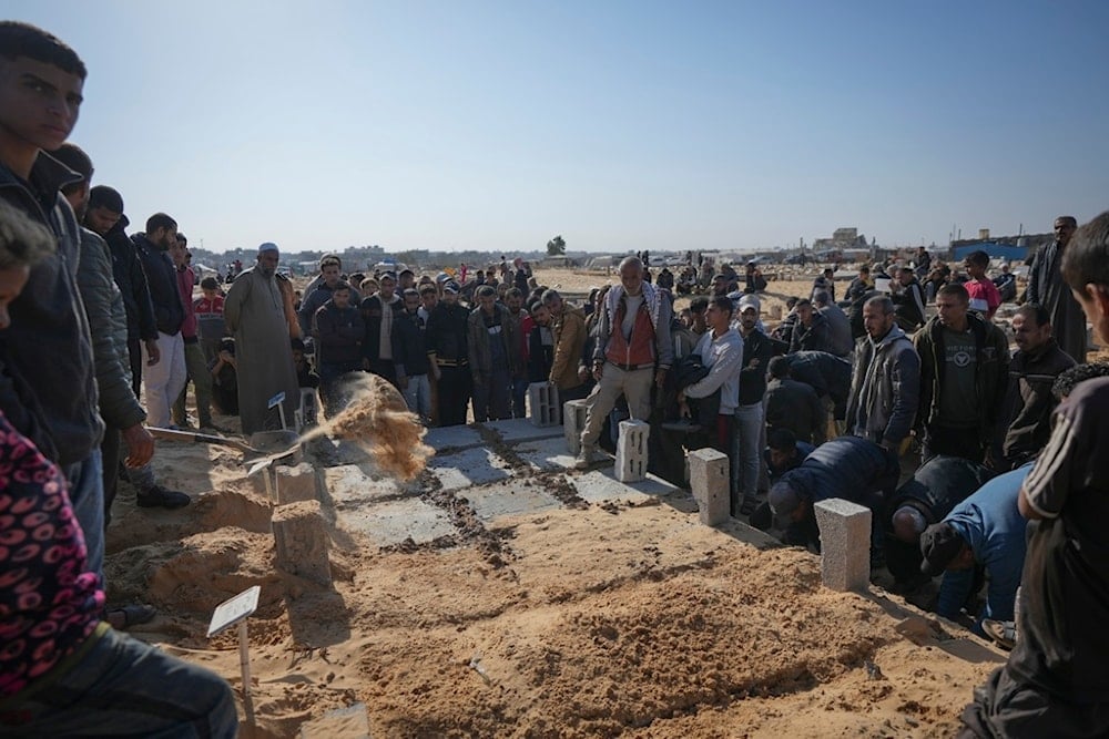 The graves of three children from the same family killed during an Israeli army strike are covered during their burial in Khan Younis, Gaza Strip, Thursday, November 21, 2024. (AP)