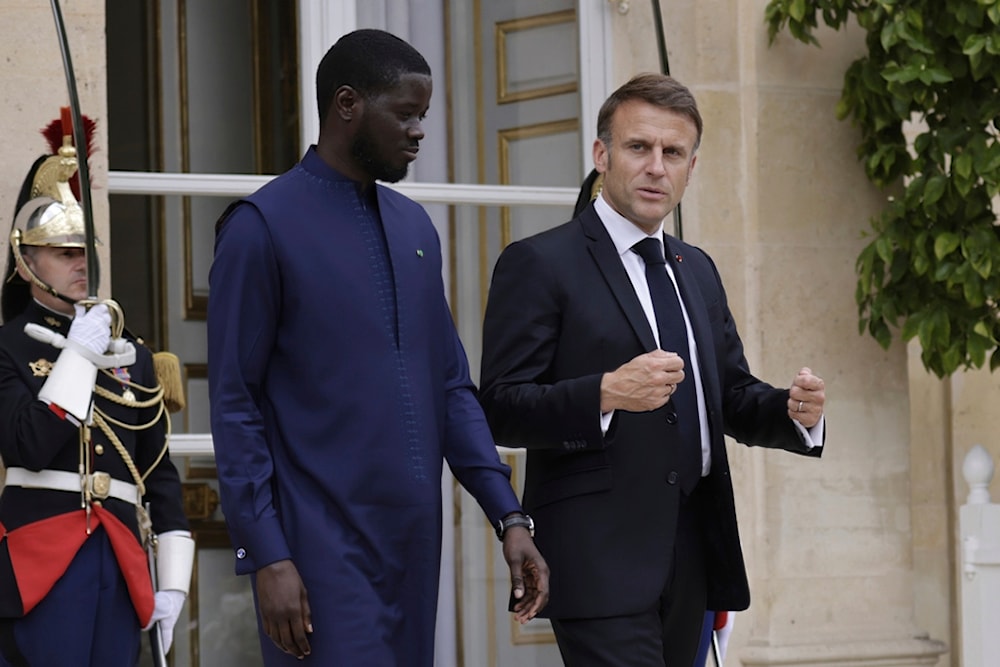 French President Emmanuel Macron and Senegalese President Bassirou Diomaye Faye leave the Elysee Palace after a lunch, in Paris, Thursday June 20 2024. (AP)