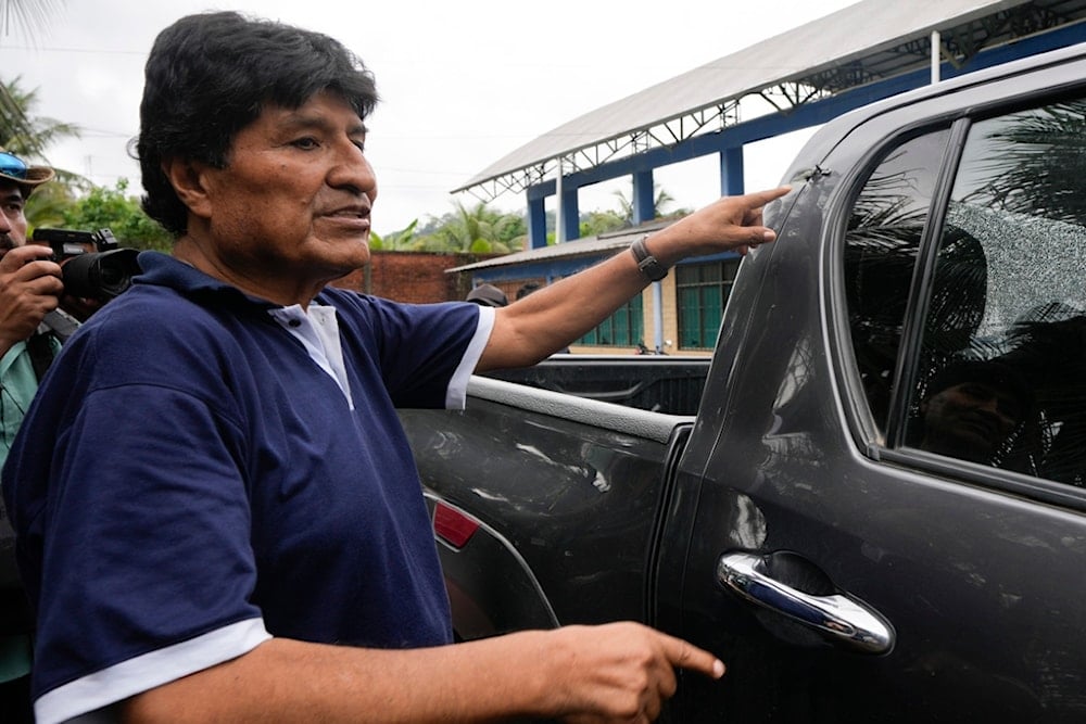 Former Bolivia's President Evo Morales points to a bullet hole on his car that he claims was the result of an assassination attempt, in Lauca N, Chapare region, Bolivia, Sunday, November 3, 2024 (AP)