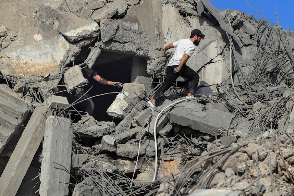 People search for victims at a destroyed building hit in an Israeli airstrike, in Ghaziyeh town, south Lebanon, Sunday, November 3, 2024 (AP)