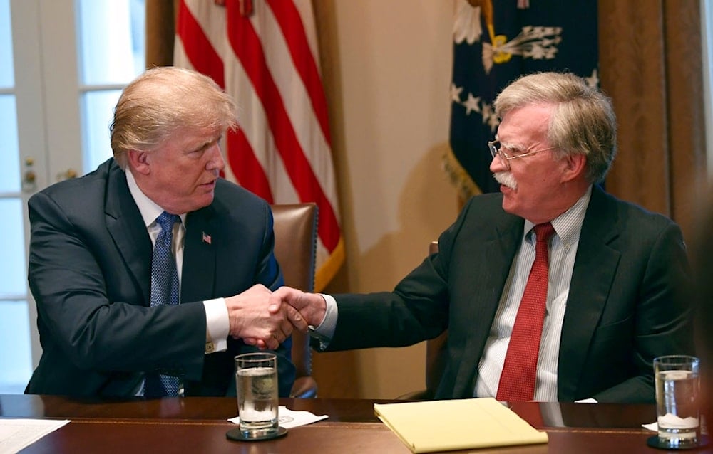 President Donald Trump, left, shakes hands with national security adviser John Bolton in the Cabinet Room of the White House in Washington, April 9, 2018 (AP)