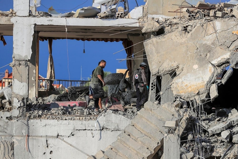 Rescue workers search for victims at a destroyed building hit in an Israeli airstrike, in Ghaziyeh town, south Lebanon, Sunday, Nov. 3, 2024. (AP)