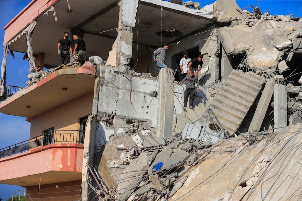 People search for victims at a destroyed building hit in an Israeli airstrike, in Ghaziyeh town, south Lebanon, Sunday, Nov. 3, 2024. (AP Photo/Mohammed Zaatari)