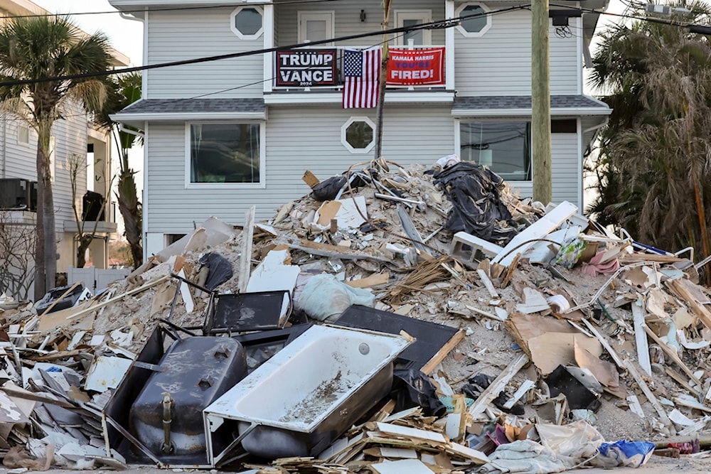 Debris remains on the streets following Hurricanes Helene and Milton as Floridians vote in the general election on Tuesday, Nov. 5, 2024, in Treasure Island, Fla. (AP Photo/Mike Carlson)