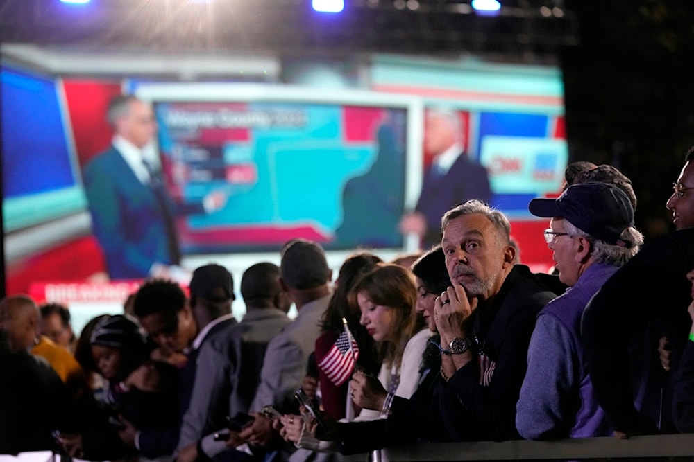 Supporters watch as results come in at an election night campaign watch party for Democratic presidential nominee Vice President Kamala Harris, Tuesday, November 5, 2024, on the campus of Howard University in Washington (AP)