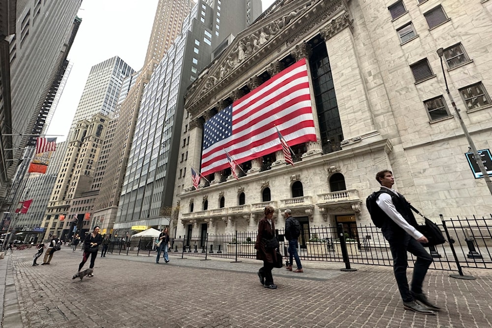 People pass the New York Stock Exchange in New York's Financial District on Tuesday, November 5, 2024 (AP)