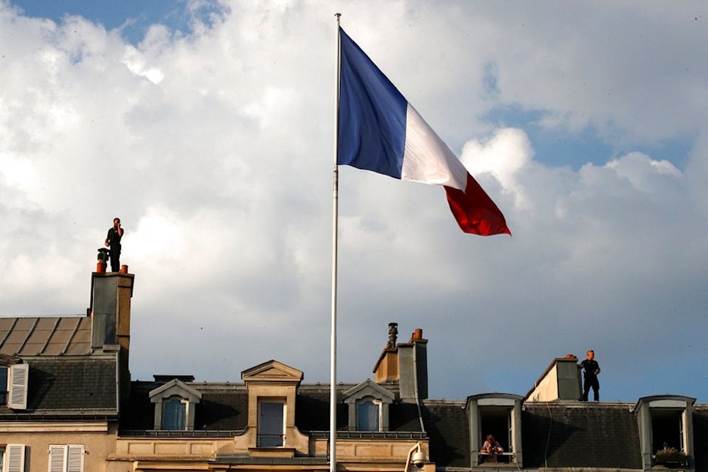 French flag flies on the roof of a building in Croatia, Monday, July 16, 2018 in Paris. (AP Photo/Francois Mori)