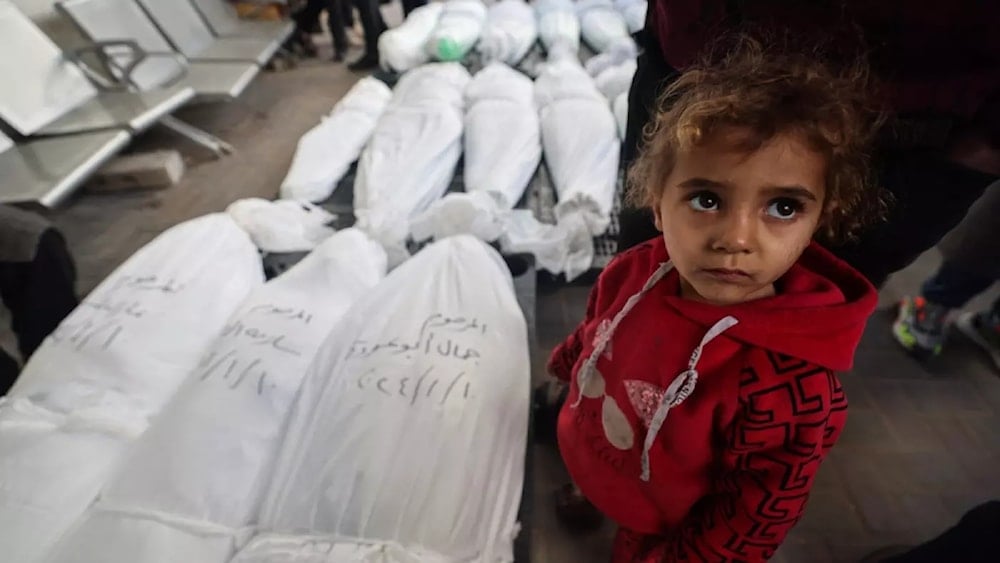  A child stands next to the bodies of family members after they were killed during Israeli bombardment, on January 10, 2024, in Rafah in the Gaza Strip. (AFP)