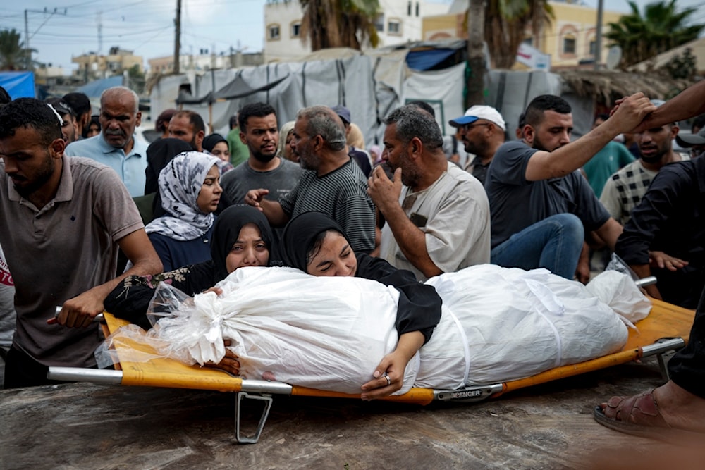 Palestinian women mourn a relative killed in the Israeli bombardment of the Gaza Strip, at a hospital in Deir al-Balah, Thursday, Aug. 22, 2024. (AP)