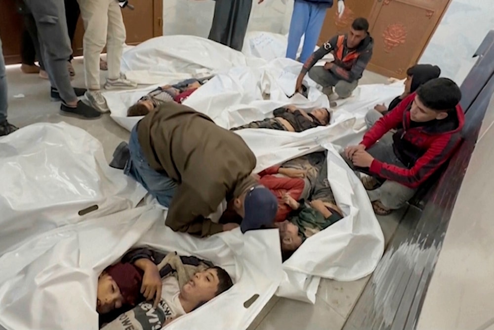  A Palestinian kisses a relative killed in Israeli airstrikes, in a morgue in the city of Khan Younis, southern Gaza Strip, Friday, Oct. 25, 2024. (AP Photo)