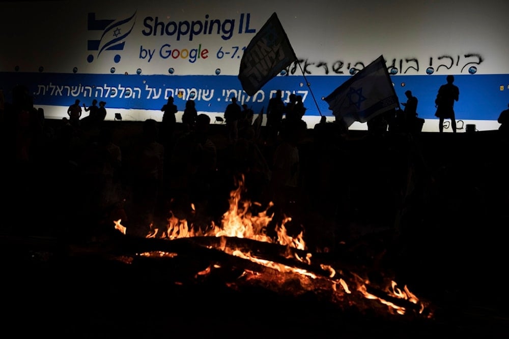 Israelis block a highway during a protest after Prime Minister Benjamin Netanyahu has dismissed Security minister Yoav Gallant, in Tel Aviv, occupied Palestine, Tuesday, Nov. 5, 2024. (AP)