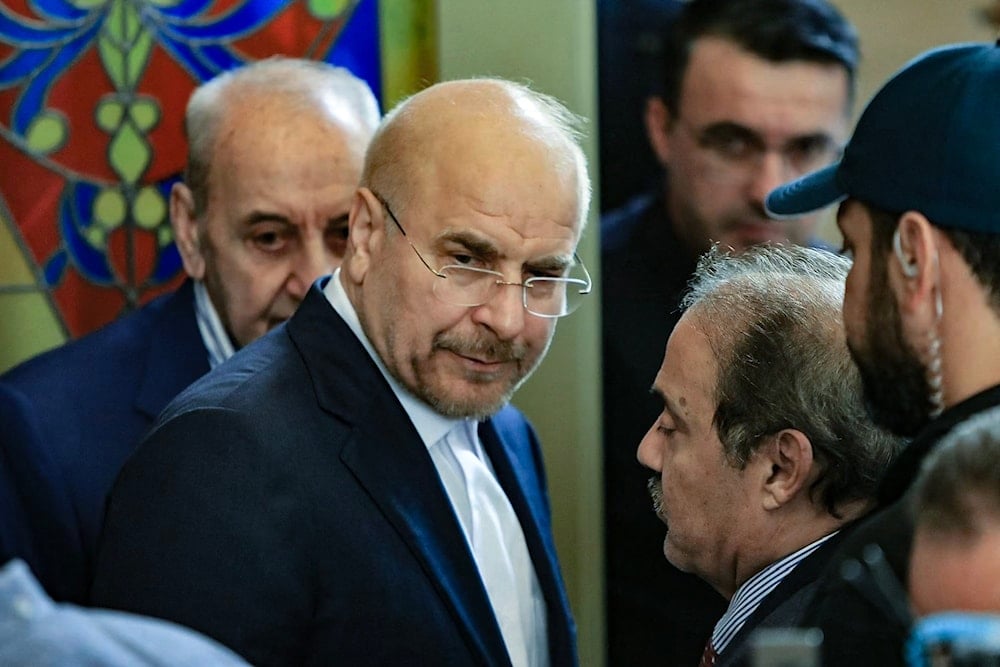 Iran's Parliament Speaker Mohammad Bagher Qalibaf (2-L)) and his Lebanese counterpart Nabih Berri (L) walk together after their meeting in Beirut on October 12, 2024. (AFP)