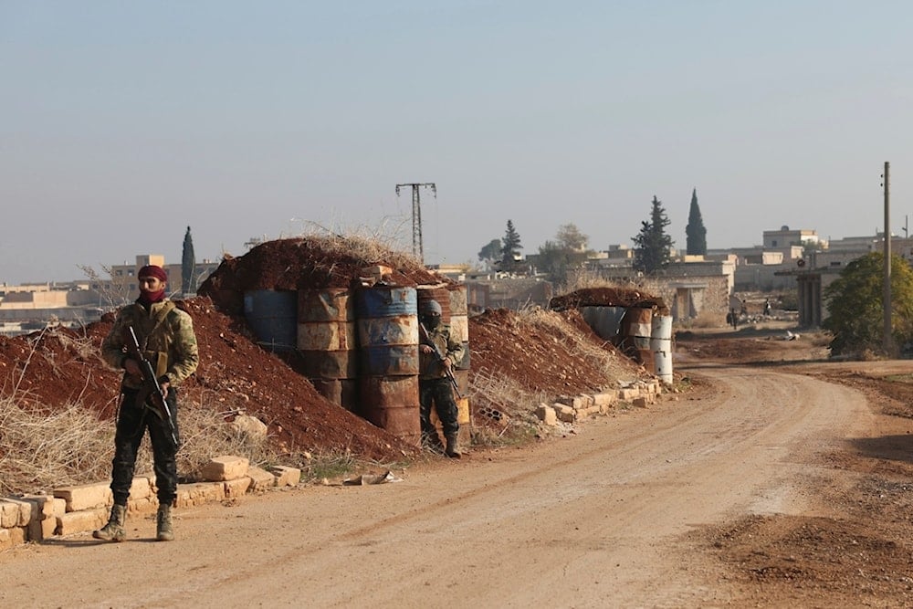 Terrorists stand guard in Kafr Halab, Aleppo countryside, Syria, Friday, Nov. 29, 2024 (AP)