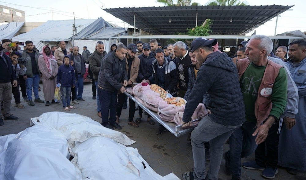 Palestinians mourn over victims during their funeral after an Israeli bombardment over night, in Al-Aqsa Martyrs hospital in Deir al-Balah, Gaza Strip, Monday, Dec. 9, 2024. (AP)