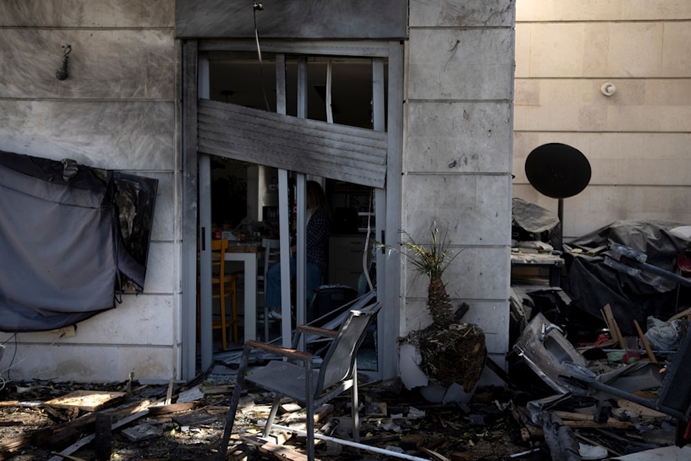 Some damage is seen at the site where a drone launched from Yemen slammed into an apartment in Yavne, central occupied Palestine, Monday, December 9, 2024 (AP)