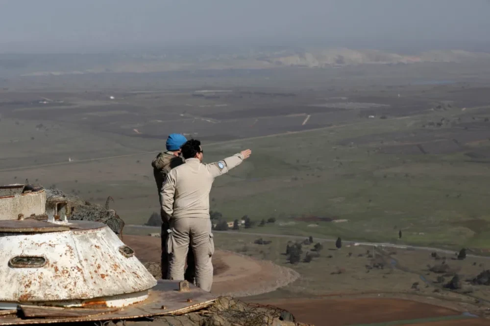 United Nations personnel stand at a lookout point as they monitor the Israel-Syria border in the Golan Heights, on Jan. 21, 2019. (AFP/Getty Images)