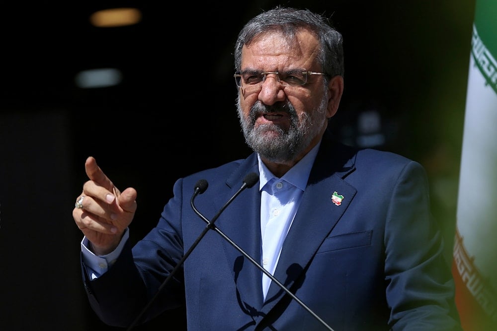 Mohsen Rezaei speaks with state-run TV journalists upon arrival to attend the final debate of the candidates, at a state-run TV studio in Tehran, Iran, on June 12, 2021. (AP)