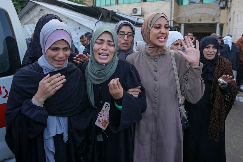 Palestinian women mourn over victims following an Israeli bombardment, at the al-Aqsa Martyrs Hospital in Deir al-Balah, Gaza Strip, Sunday, December 8, 2024 (AP)