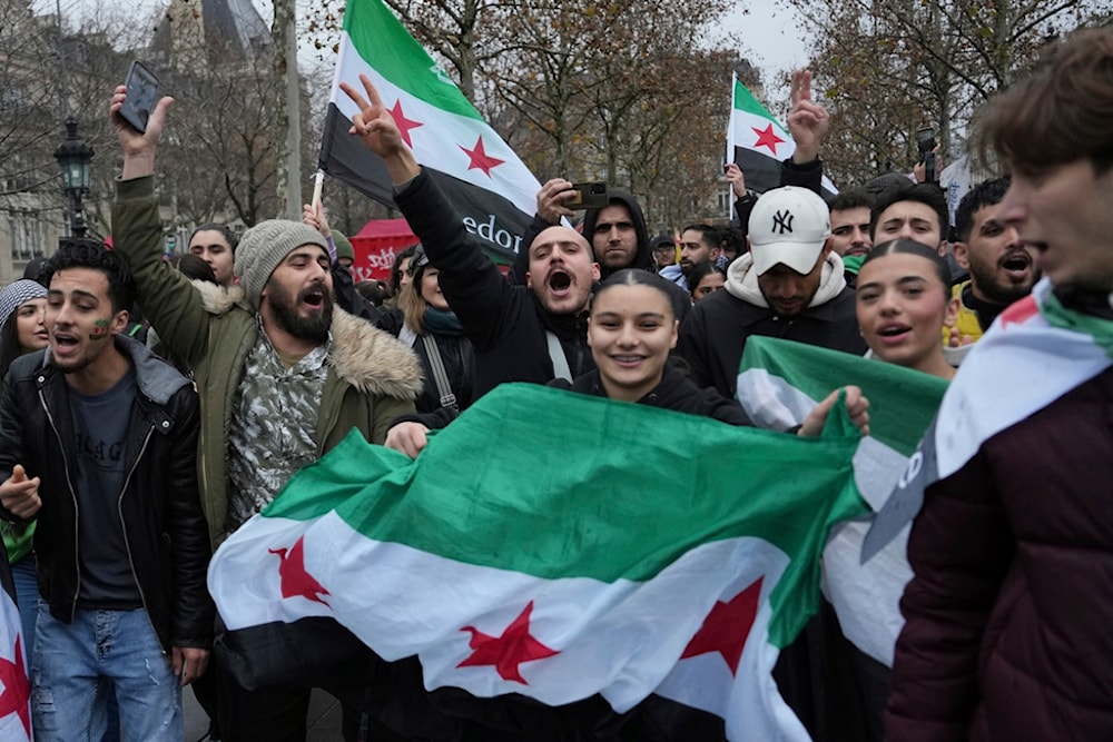 Syrians living in France gather on Republique Square after the Syrian government fell, Sunday, Dec. 8, 2024, in Paris (AP)