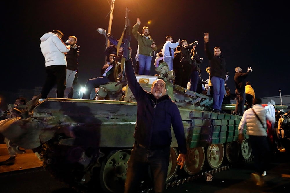 Syrians celebrate the arrival of opposition fighters in Damascus, Syria, on December 8, 2024. (AP)