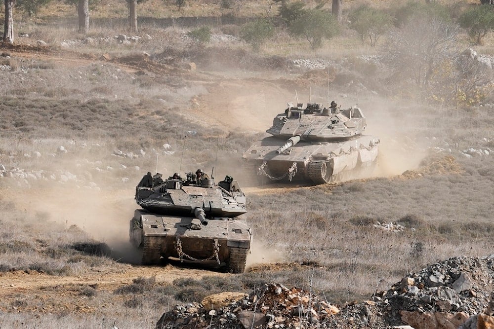 Israeli tanks maneuver next to the security fence near the so-called Alpha Line that separates the occupied Golan Heights from Syria, in the town of Majdal Shams, Wednesday, December 11, 2024 (AP)