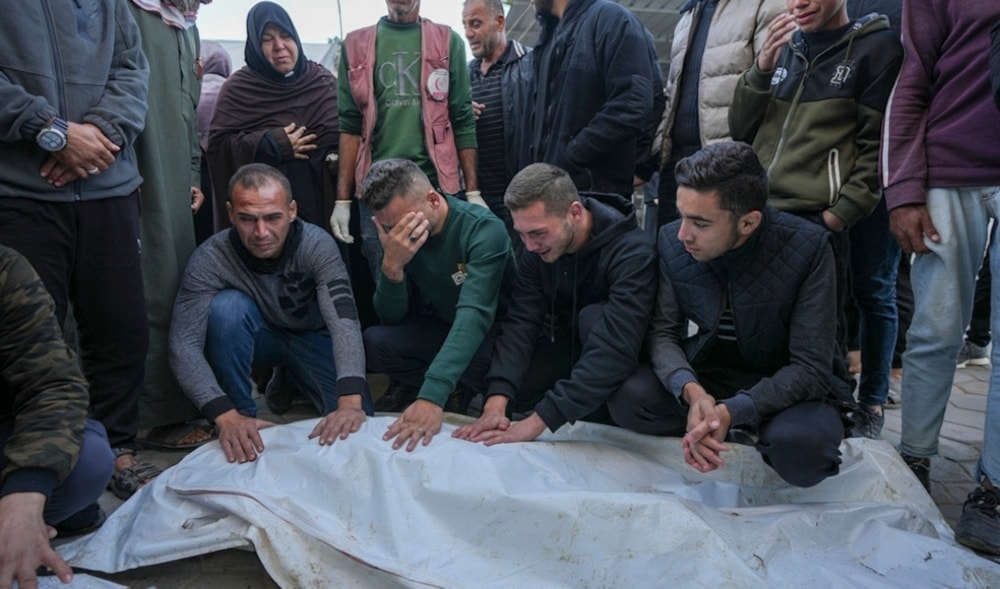 Palestinain mourn over victims during their funeral after an Israeli bombardment overnight in Al-Aqsa Martyrs hospital in Deir al-Balah, Gaza Strip, Monday December 9,2024. (AP)