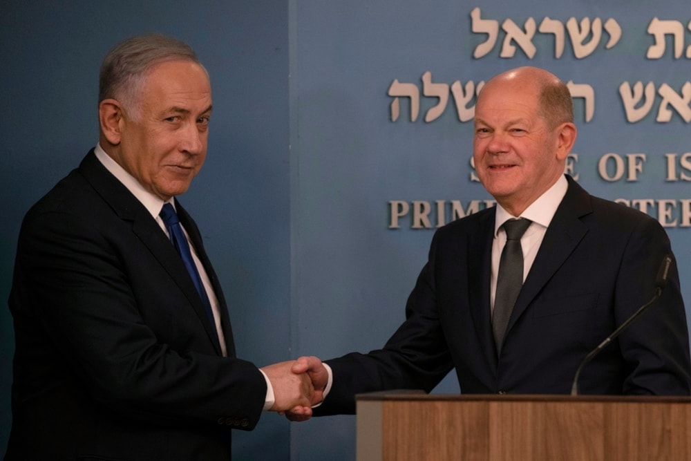 Chancellor Olaf Scholz shake hands after delievering their speeches in Occupied al-Quds on March 17,2024. (AP)