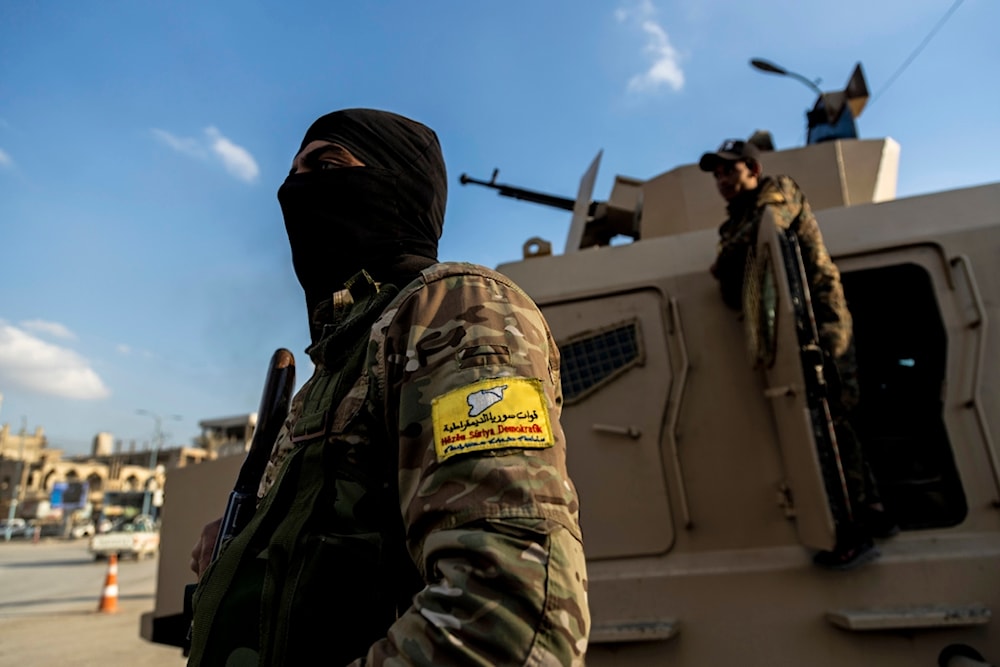 US-backed Syrian Democratic Forces (SDF) fighters stand guard in Raqqa, Syria, on February 7, 2022 (AP)