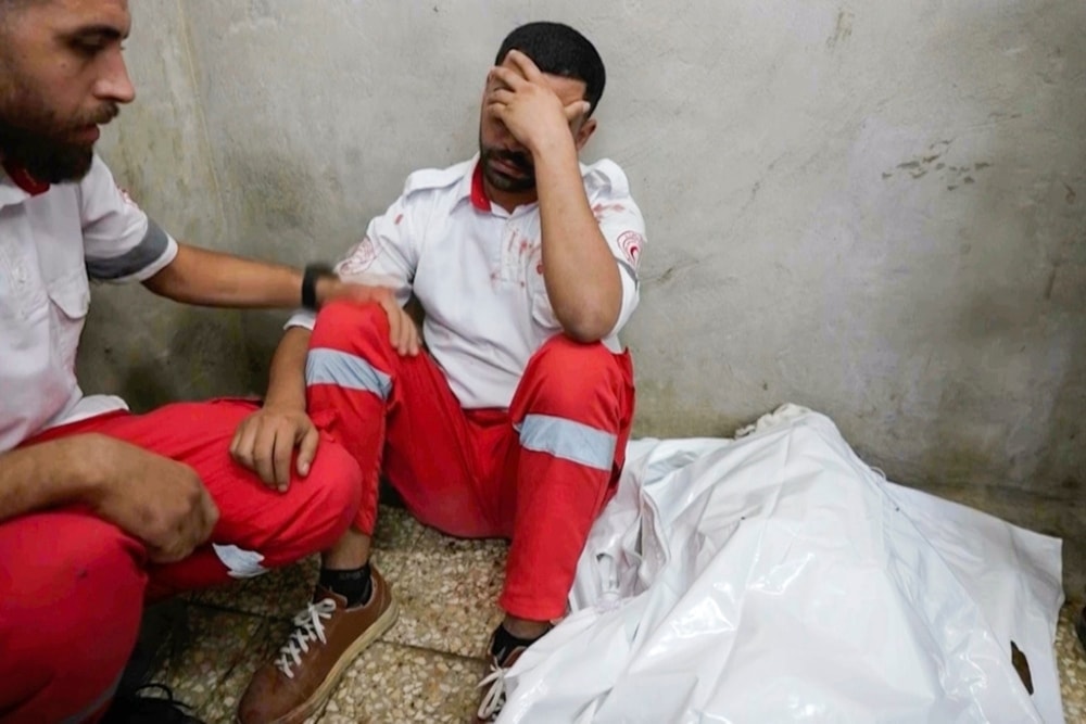 Screen grab from Associated Press video shows medic Abed al Aziz Bardini mourns next to the body of his mother on October, 2024 , in Dier al-Balah in Gaza Strip. (AP)