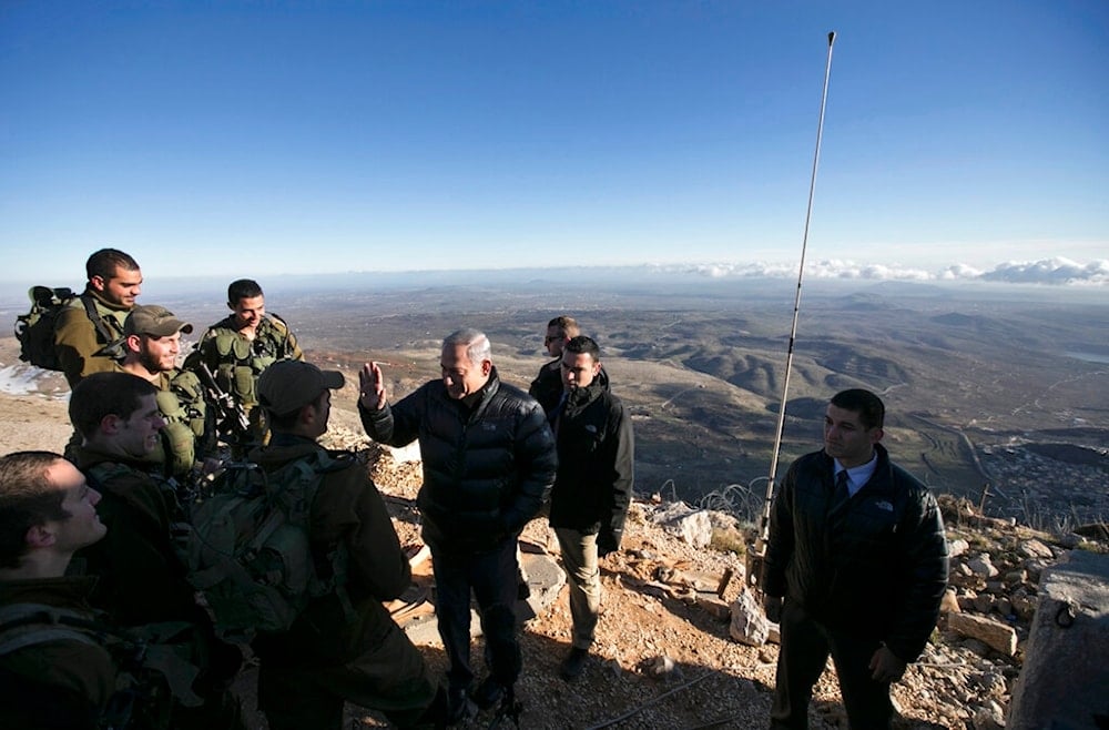 Israeli Prime Minister Benjamin Netanyahu, center, talks with Israeli soldiers at a military outpost during a visit at Mount Hermon in the occupied Golan Heights overlooking the Palestine-Syria border on Feb. 4, 2015. (AP)