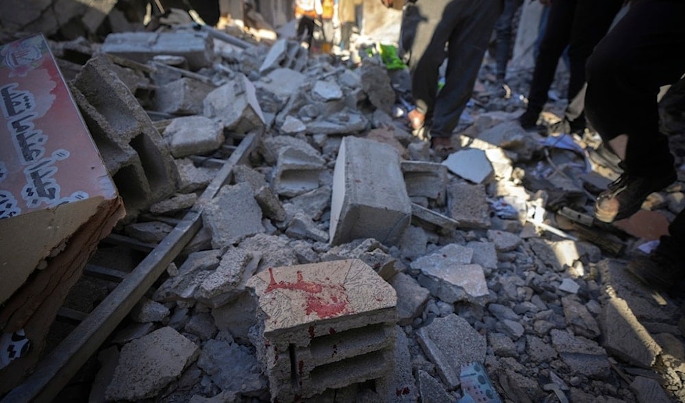 A stain of blood is seen among the rubble of a building hit by an Israeli airstrike that apparently targeted a municipal meeting in Deir al-Balah, central Gaza Strip, Palestine, Dec. 14, 2024. (AP)