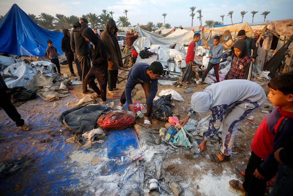 Palestnain Families check their last belongings after the Israeli airstrikes bombed their tents on December 9, 2024. (@UNRWA/ X)