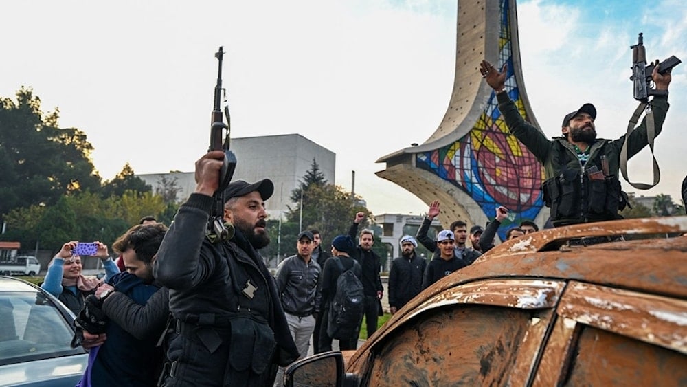 New regime forces celebrate the fall of the Syrian government at Umayyad Square in Damascus on December 8.  (AFP)