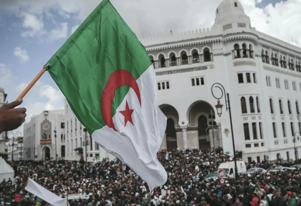 People chant slogans and wave flags during a demonstration in Algiers, Algeria on April 10, 2019. (AP)