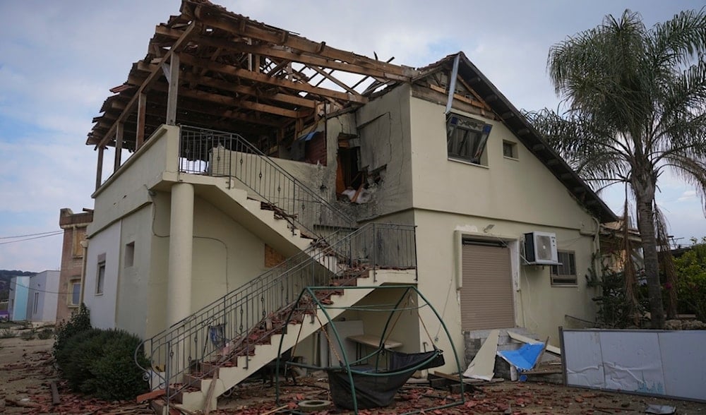 A damaged house is seen in the agricultural settlement of Avivim, in upper al-Jalil, 