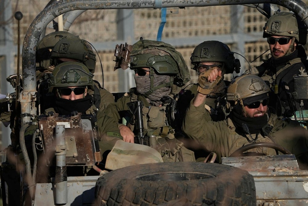 Israeli soldiers stand on an armored vehicle after crossing the security fence near the so-called Alpha Line that separates the Israeli-occupied Golan Heights from Syria, in the town of Majdal Shams, Monday, December 16, 2024 (AP)