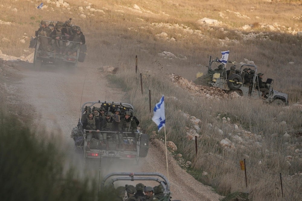 Israeli occupation soldiers cross the security fence moving towards the so-called Alpha Line that separates the Israeli-annexed Syrian Golan Heights from Syria, in the town of Majdal Shams, Dec. 15, 2024. (AP)