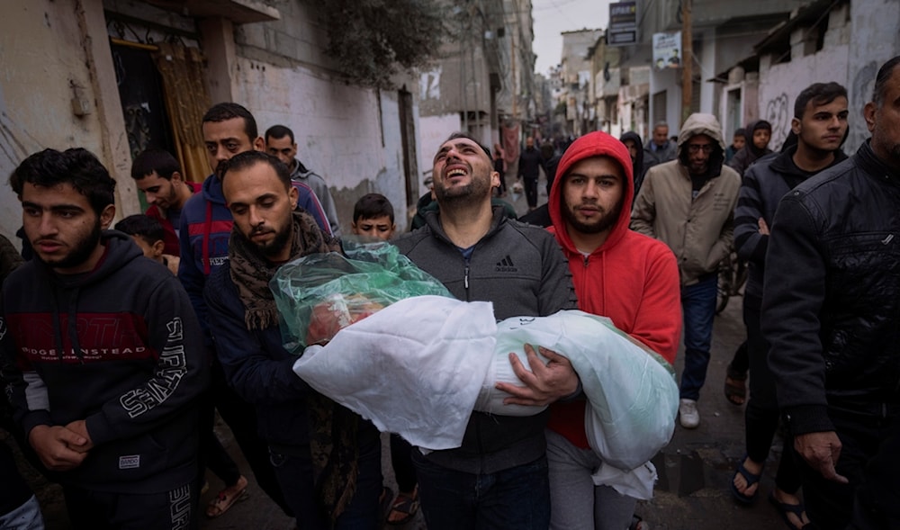 Mohammad Shouman carries the body of his daughter, Masa, who was killed in an Israeli bombardment of the Gaza Strip, during her funeral in Rafah, southern Gaza, Jan. 17, 2024. (AP)